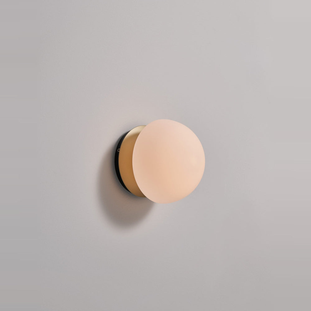 Pensee Wall Sconce by Seed Design in Champagne Gold, styled in a room setting