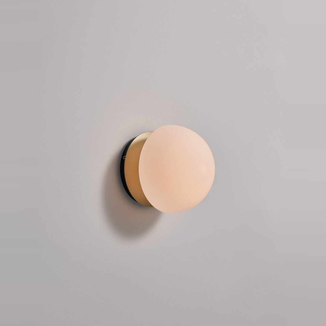 Pensee Wall Sconce by Seed Design in Champagne Gold, styled in a room setting