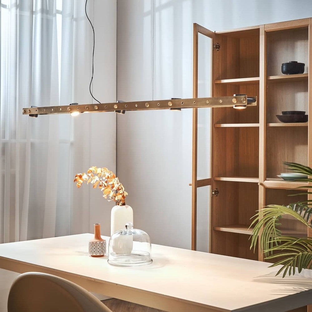 Tram Pendant by Seed Design in Brass, styled in a room setting