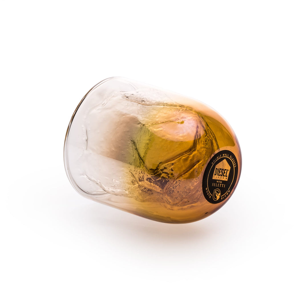 Seletti Cosmic Diner Meteorite Glass Short, glass on its side showing the amber base and label