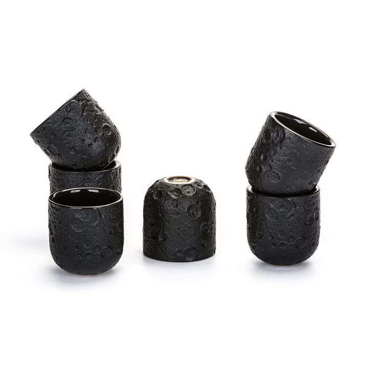 Seletti Cosmic Diner Lunar Coffee Cups (Set of 6), six black cratered stoneware espresso cups, some stacked