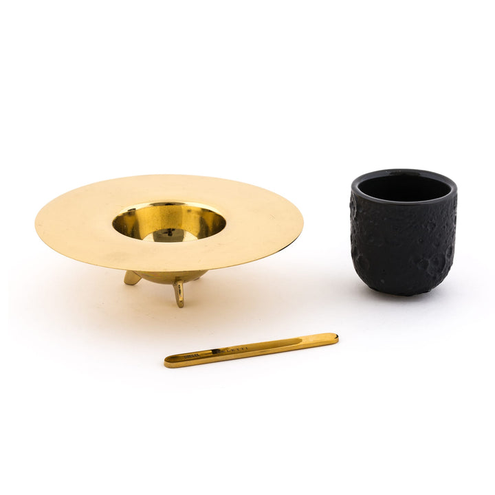 Seletti Cosmic Diner Lunar Coffee Set, cup, ringed brass saucer and stirrer laid out separately