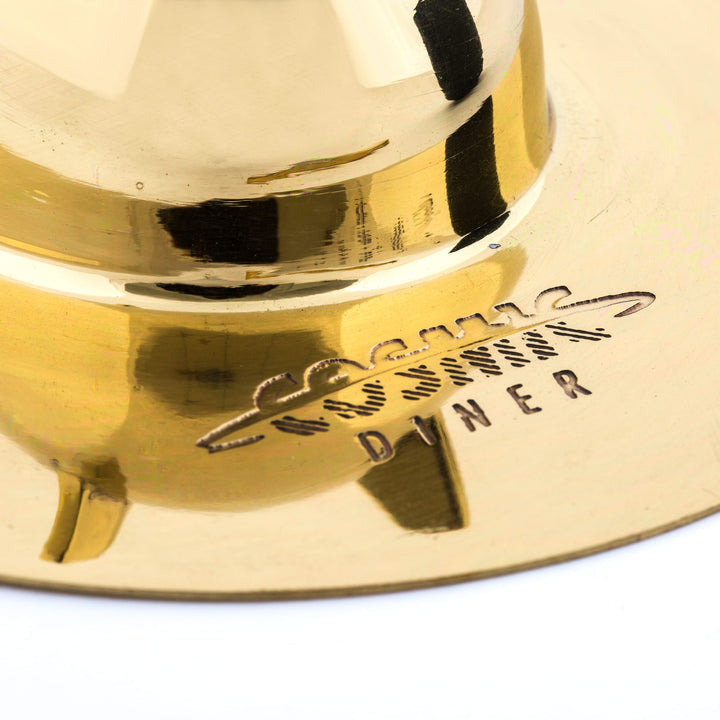 Seletti Cosmic Diner Lunar Coffee Set, close-up of the Cosmic Diner logo engraved in the brass