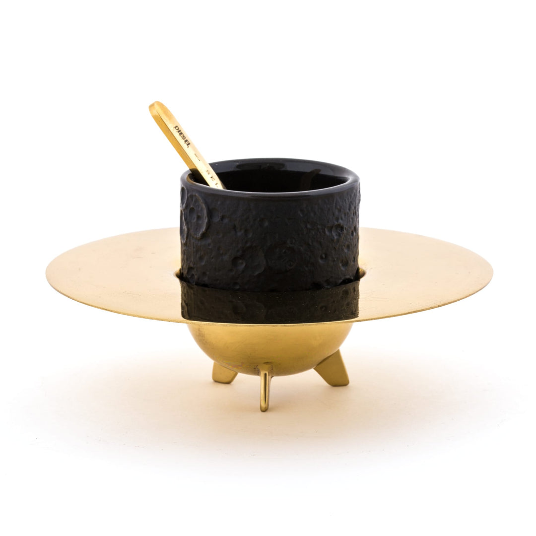 Seletti Cosmic Diner Lunar Coffee Set, black cratered espresso cup on a ringed brass saucer stand with brass stirrer