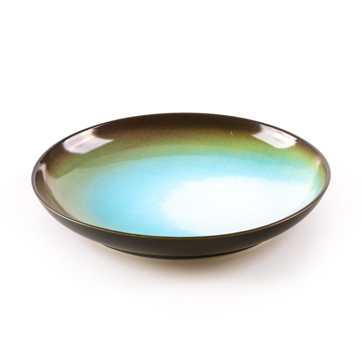 Seletti Cosmic Diner Uranus Soup Plate, angled view into the deep cyan-blue bowl