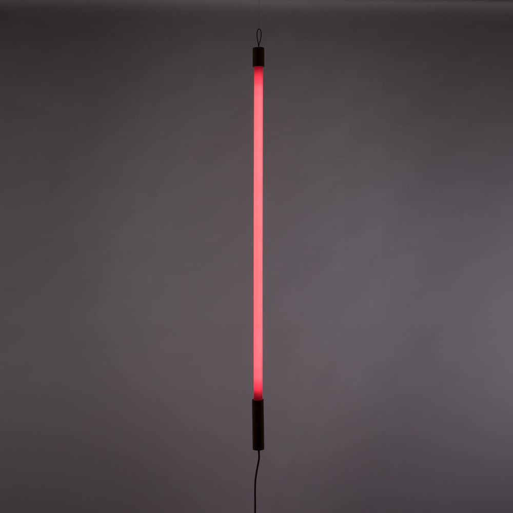 Seletti Linea LED Pink, pink tube lit upright against a gray wall