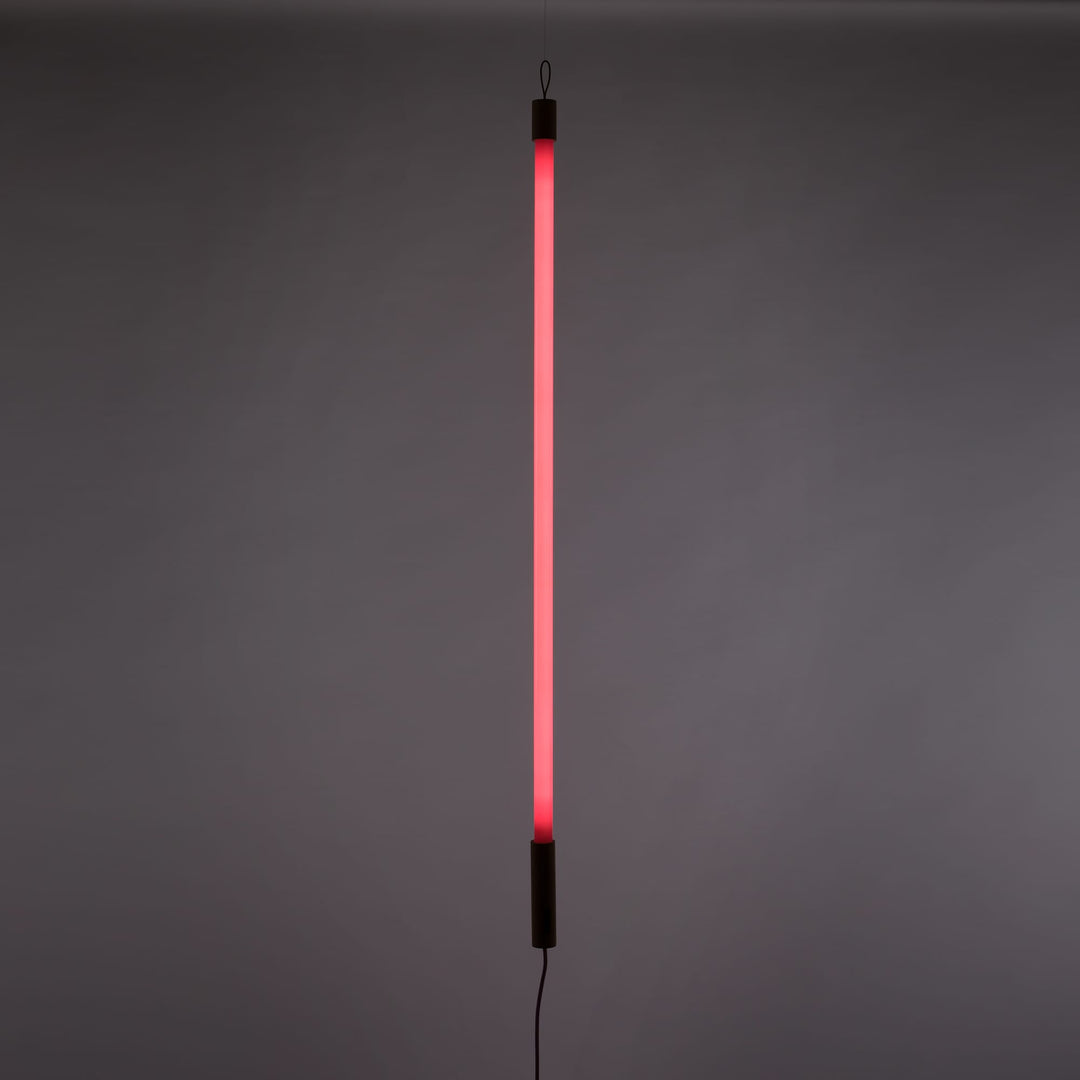 Seletti Linea LED Pink, pink tube lit upright against a gray wall