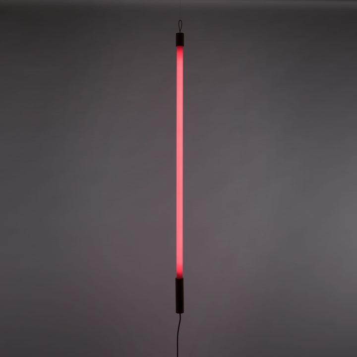 Seletti Linea LED Pink, pink tube lit upright against a gray wall