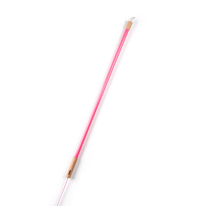 Seletti Linea LED Pink, pink tube leaning at an angle on white