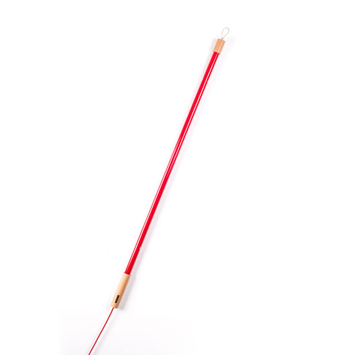 Seletti Linea LED Red, red tube leaning diagonally, wood cap and cord visible