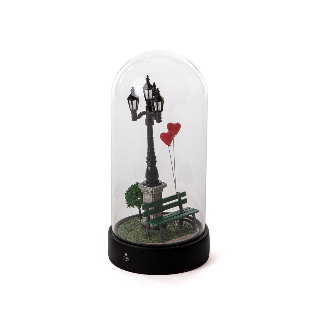Seletti My Little Valentine, side view of the bench, trees and heart balloons