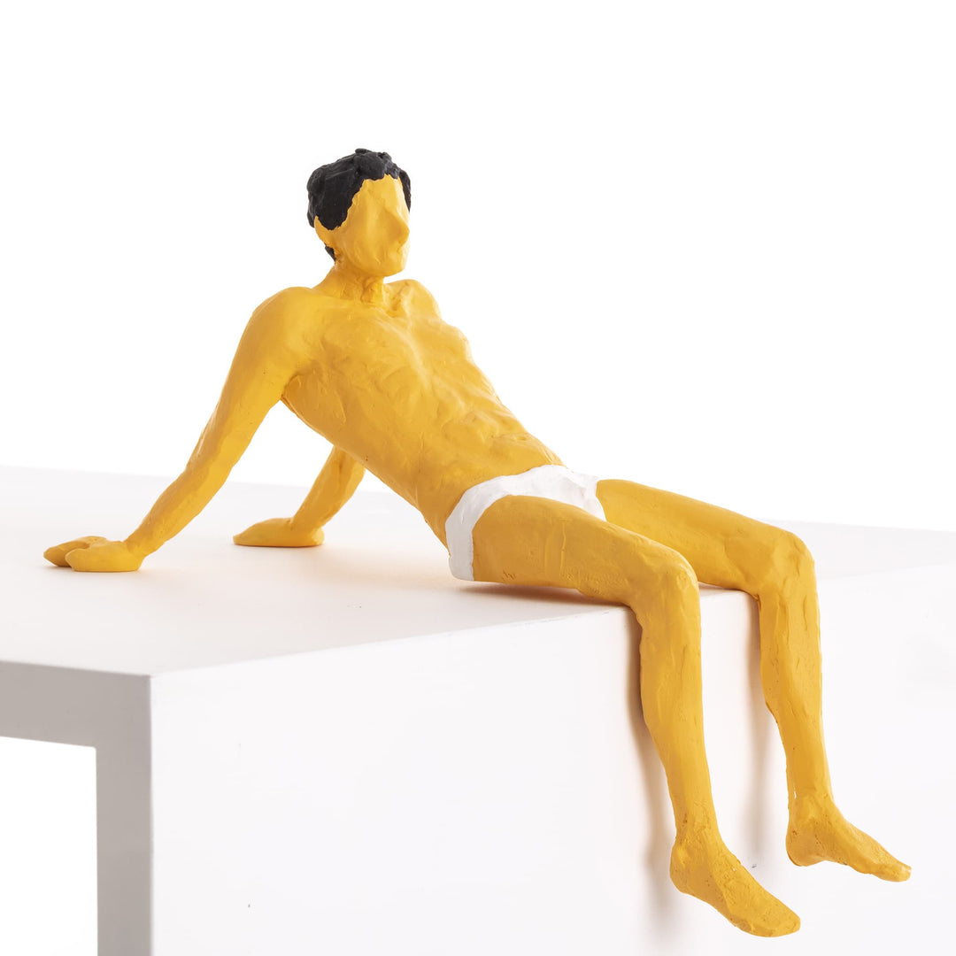 Seletti Love Is a Verb Pierrot Figurine, ochre resin man leaning back on his hands at the edge of a ledge