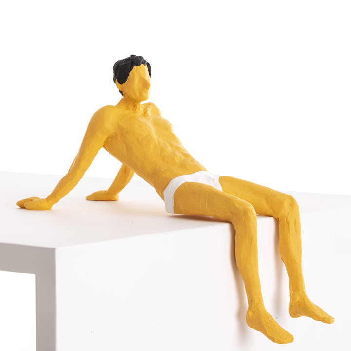 Seletti Love Is a Verb Pierrot Figurine, ochre resin man leaning back on his hands at the edge of a ledge