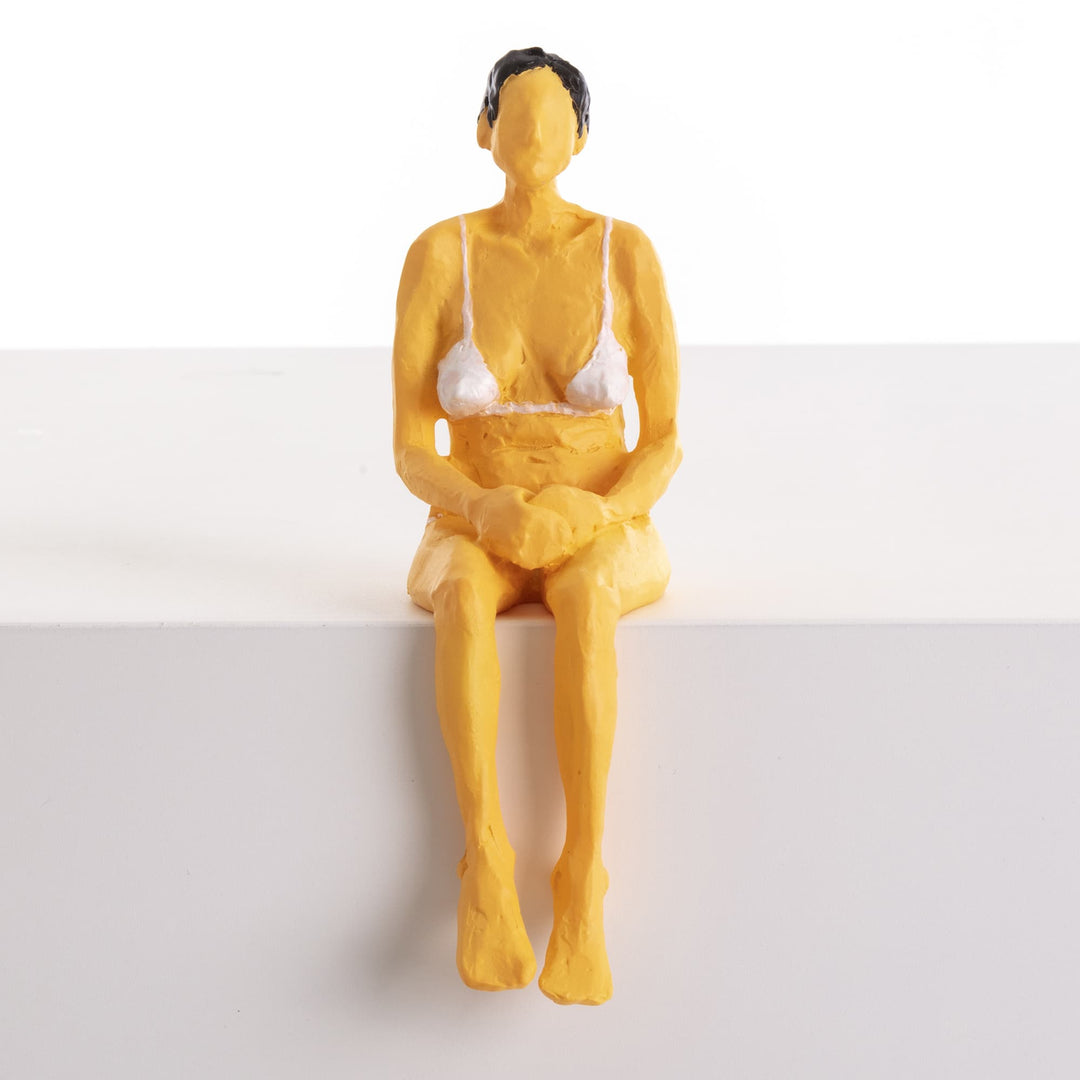 Seletti Love Is a Verb Penelope Figurine, front view of the figure perched on a white block