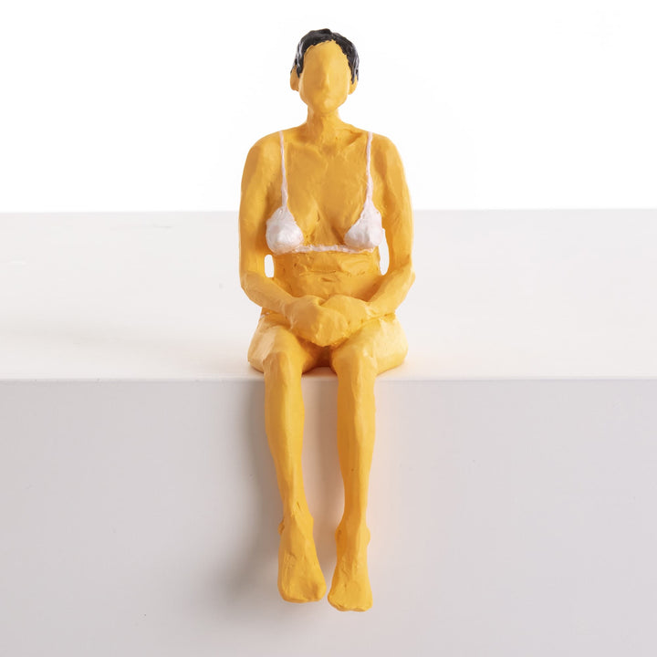 Seletti Love Is a Verb Penelope Figurine, front view of the figure perched on a white block