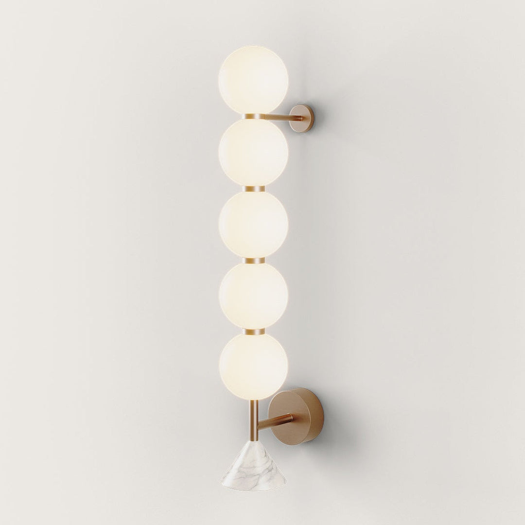Soko Wall Lamp, 5 spheres, five stacked opal glass globes on an aged gold frame