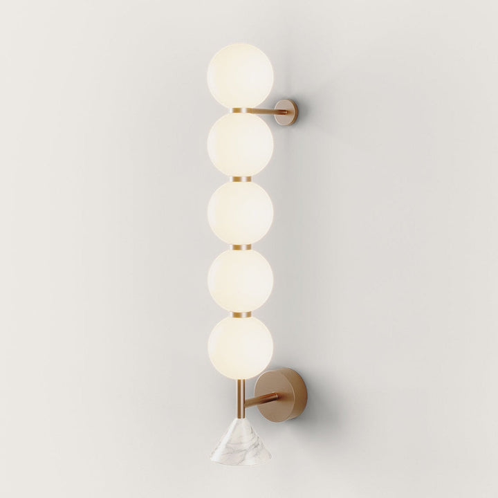 Soko Wall Lamp, 5 spheres, five stacked opal glass globes on an aged gold frame