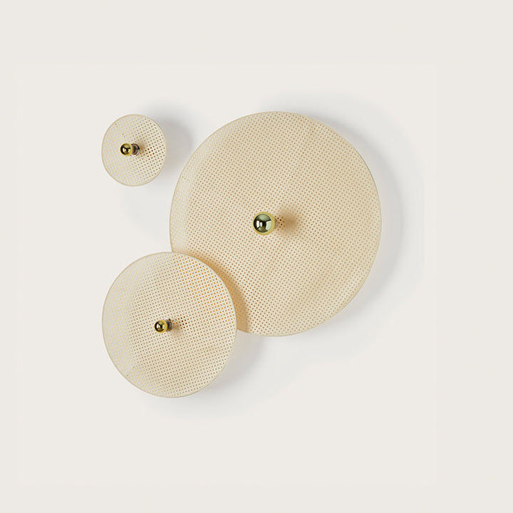 Three beige circular Wall Lamps with small gold elements on a white background