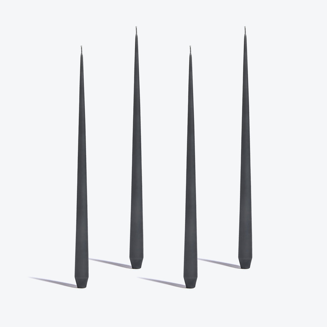 Tapered Candle, Set of 4 — four tall Dark Grey candles standing upright on a white background