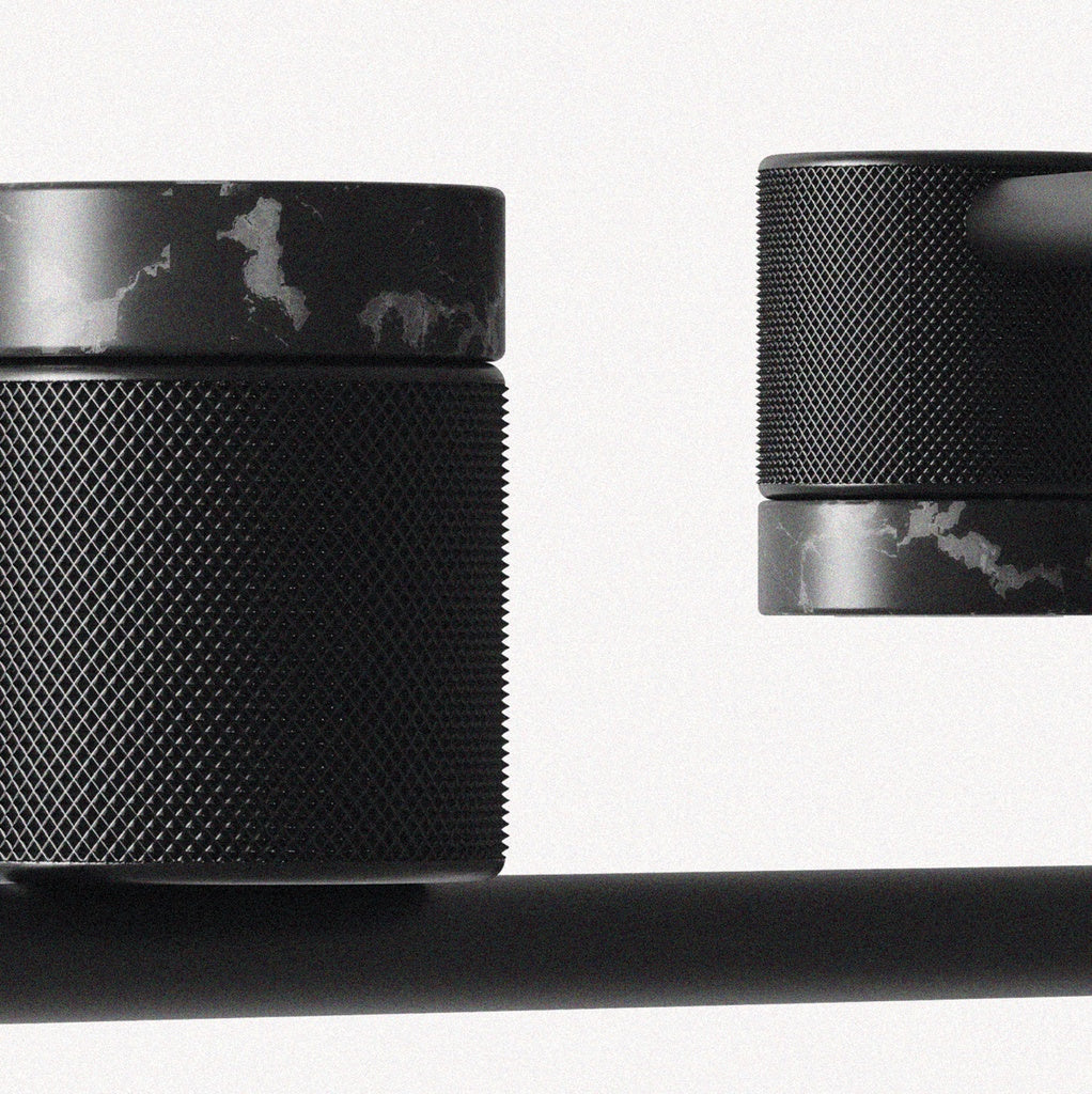 Close-up of Tea Chandelier knurled matt black heads with black marble rings