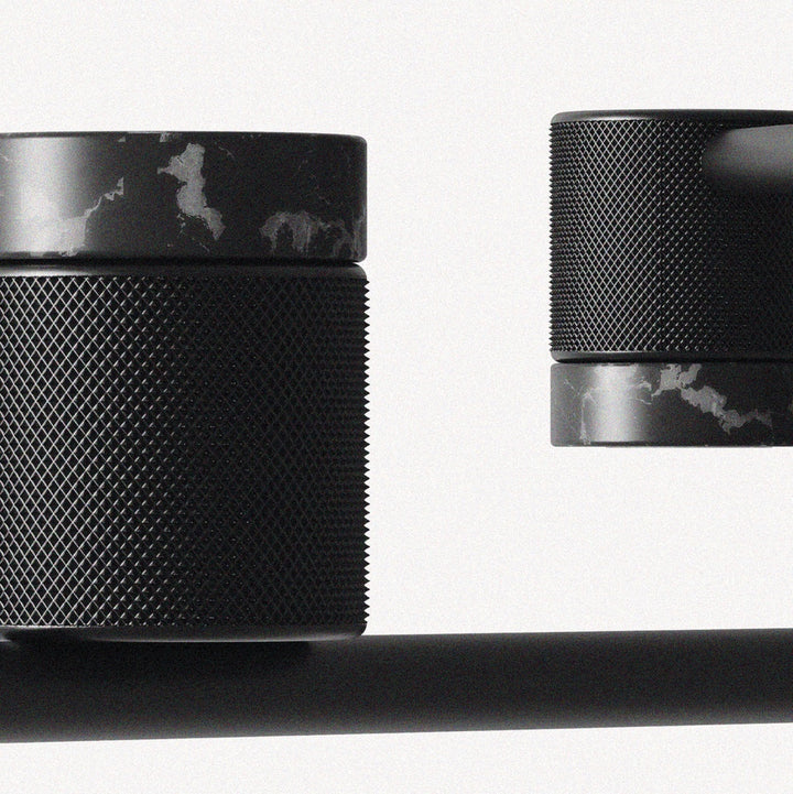 Close-up of Tea Chandelier knurled matt black heads with black marble rings