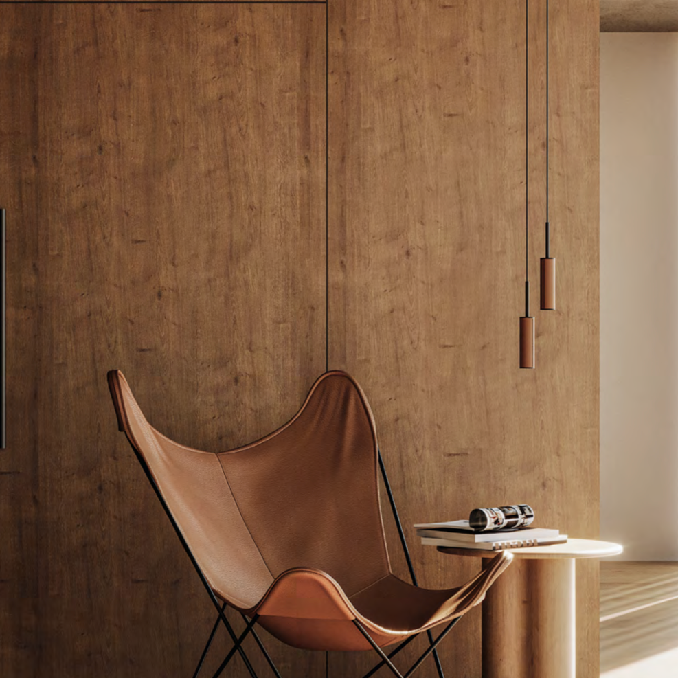 Tura Pendant Lamp pair in tan leather above a leather butterfly chair against a wood-panelled wall