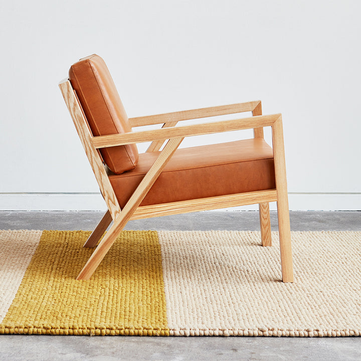 Mid-century modern armchair with caramel leather and oak frame