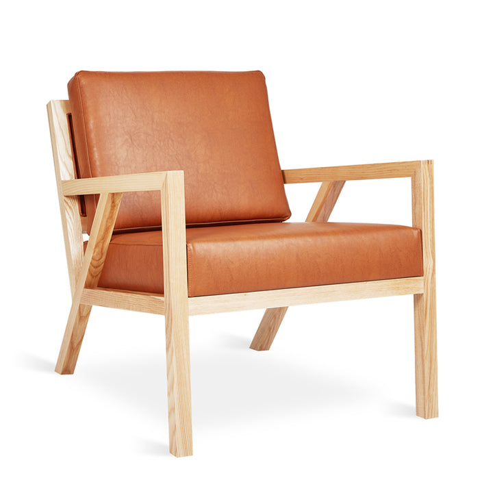 Mid-century modern armchair with caramel leather upholstery and oak frame
