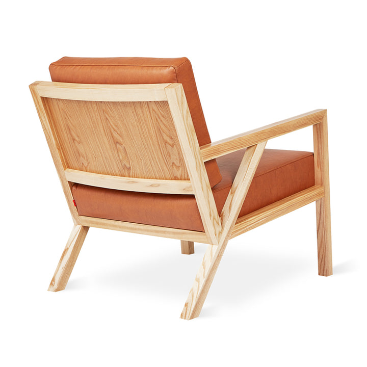 Mid-century oak armchair with caramel leather cushions, minimalist design