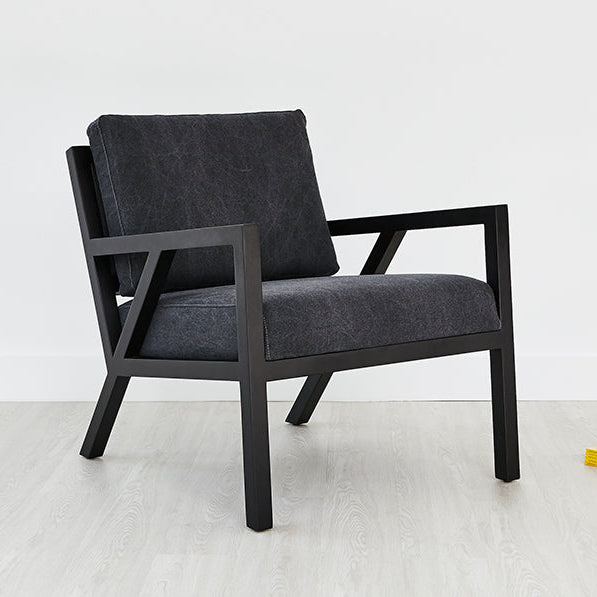 Modern armchair with dark wood frame and charcoal upholstery, minimalist design