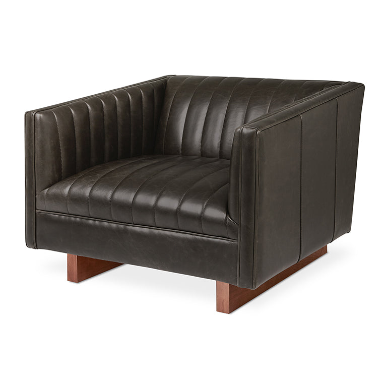 Dark leather armchair with tufted detailing and walnut wood legs