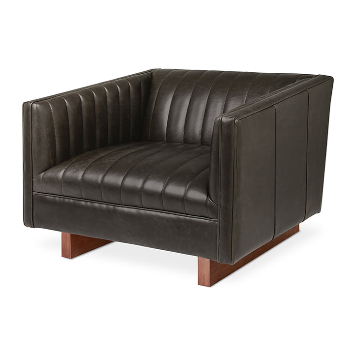 Dark leather armchair with tufted detailing and walnut wood legs