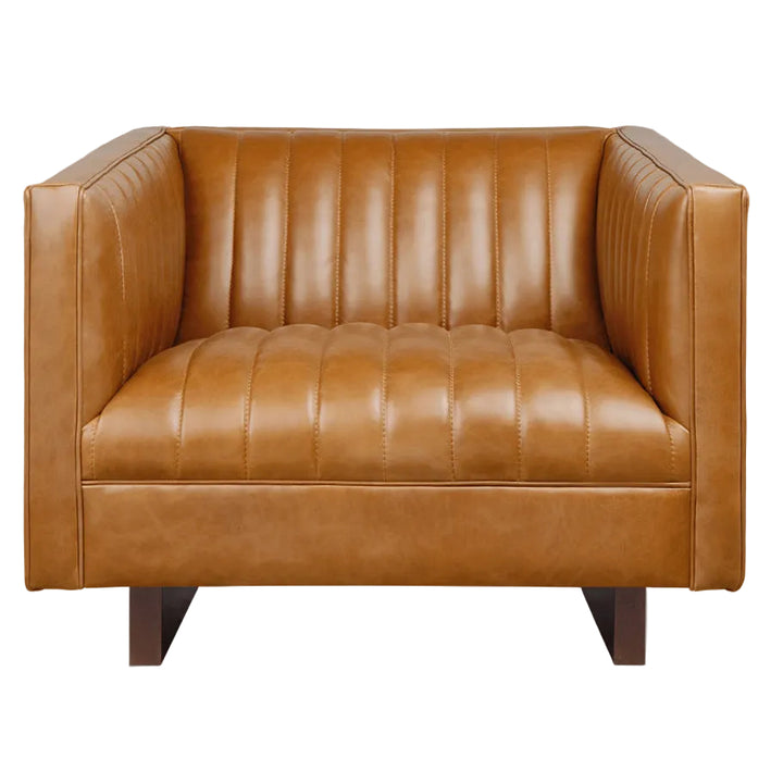 Tan leather armchair with vertical channel tufting and dark wood legs
