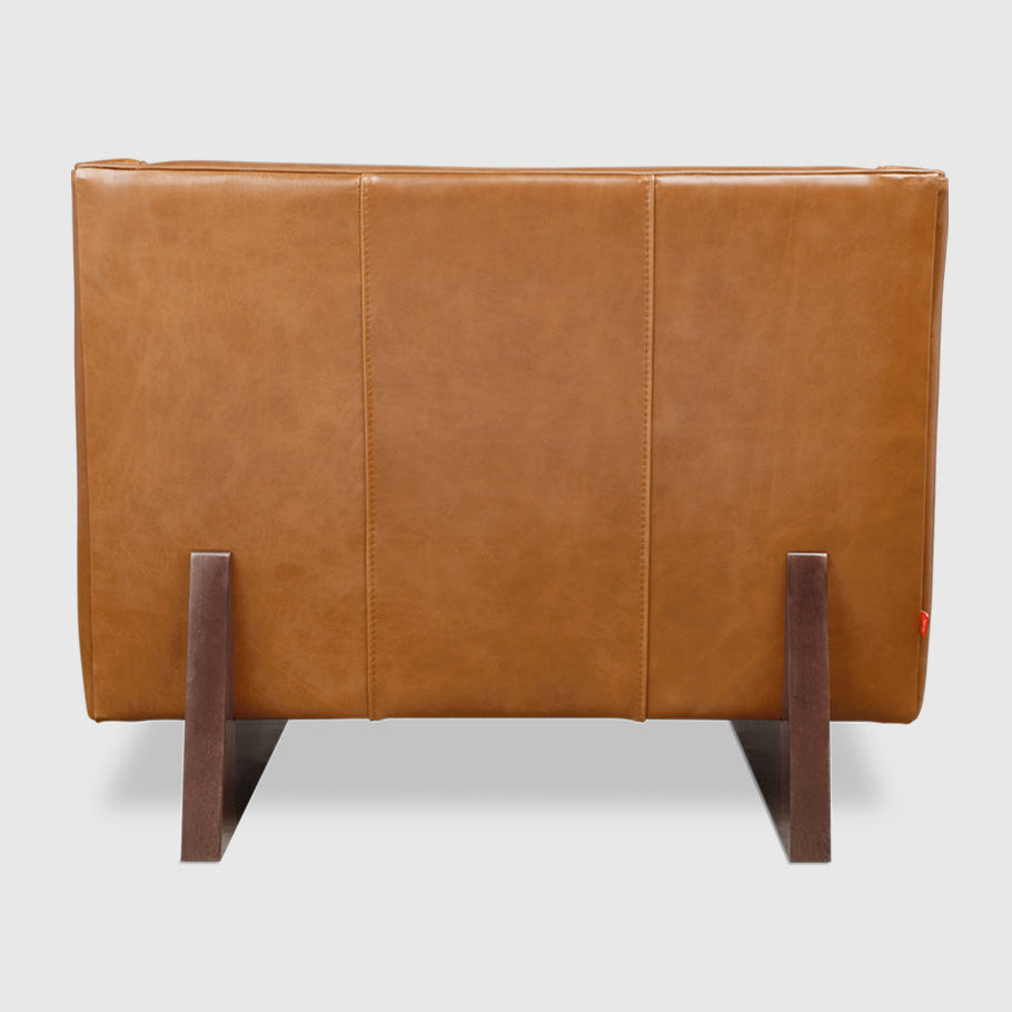 Tan leather armchair with dark wood legs, modern minimalist design