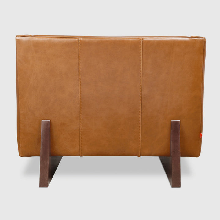 Tan leather armchair with dark wood legs, modern minimalist design