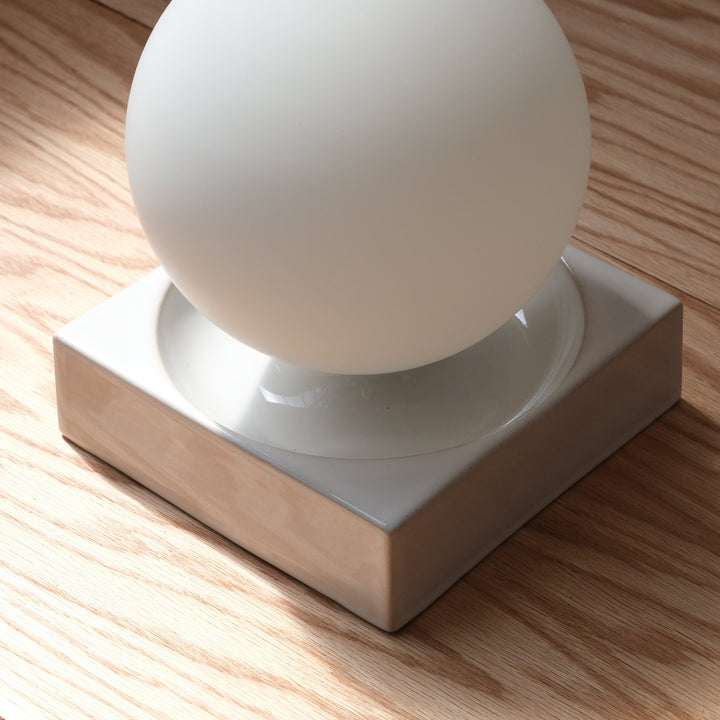 Frosted glass sphere on ceramic base, modern minimalist decor