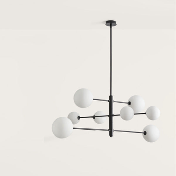 Atom Chandelier in Matt Black with eight opal globes on staggered black arms, angled view on a light background