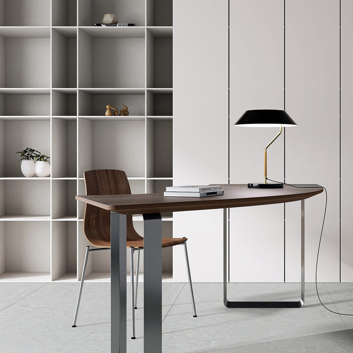Aider Table Lamp with black shade on a walnut desk in a home office with open white shelving