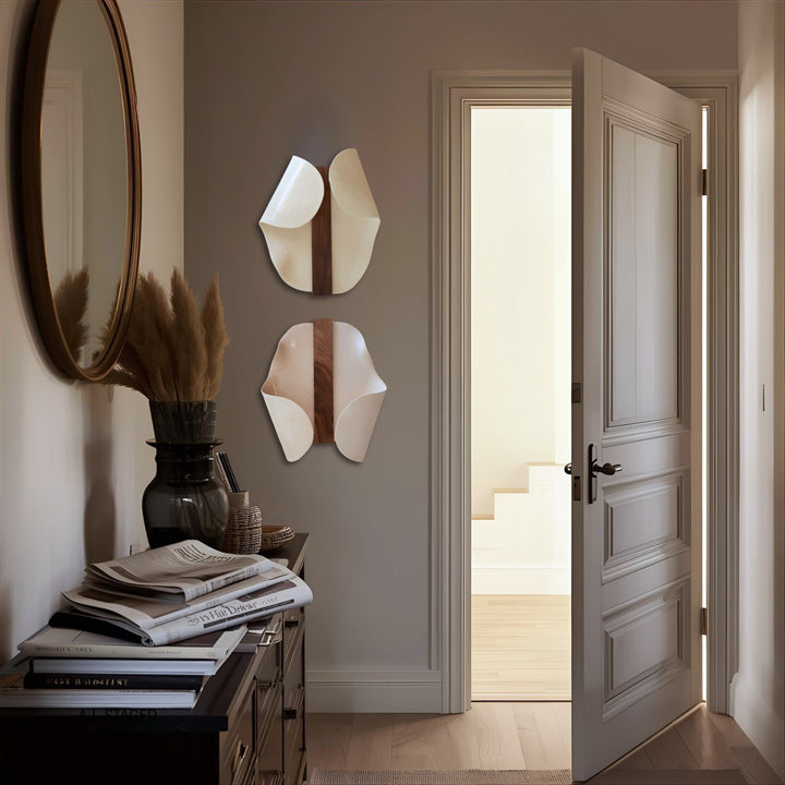 Abundance Duo I in white stoneware hung in an entryway beside a round mirror