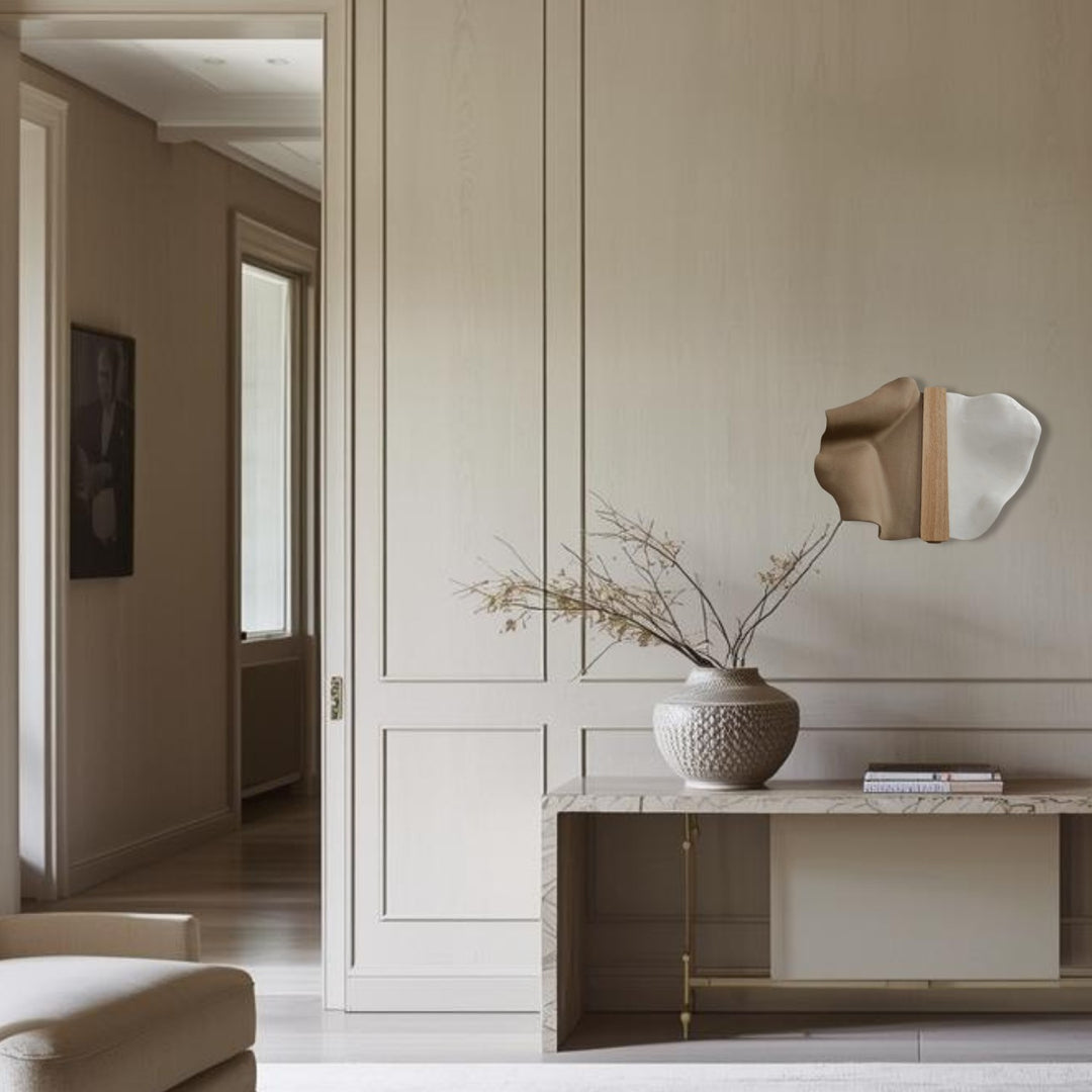 Abundance Small wall sculpture styled above a stone console in a pale panelled room