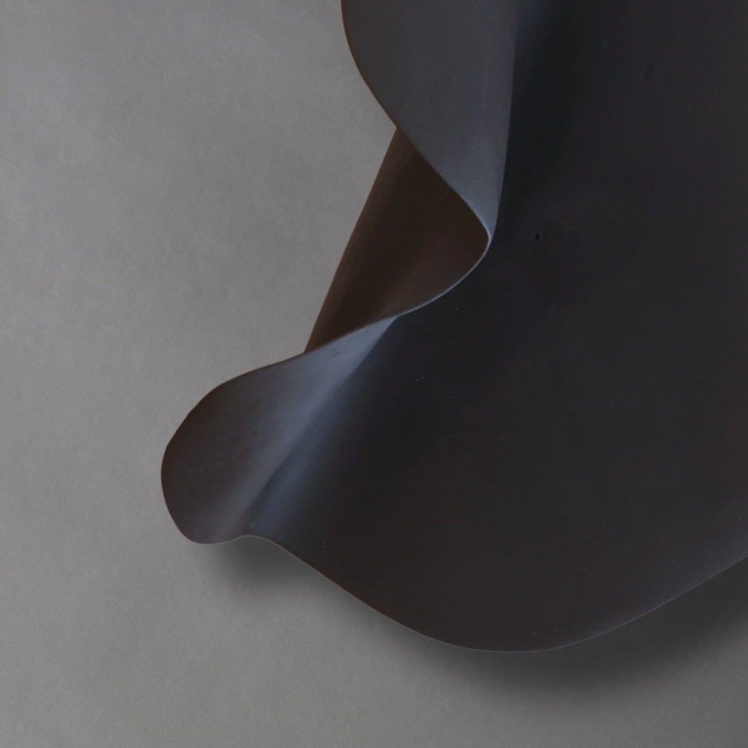 Abundance Small, close-up of the black stoneware curve and shadow
