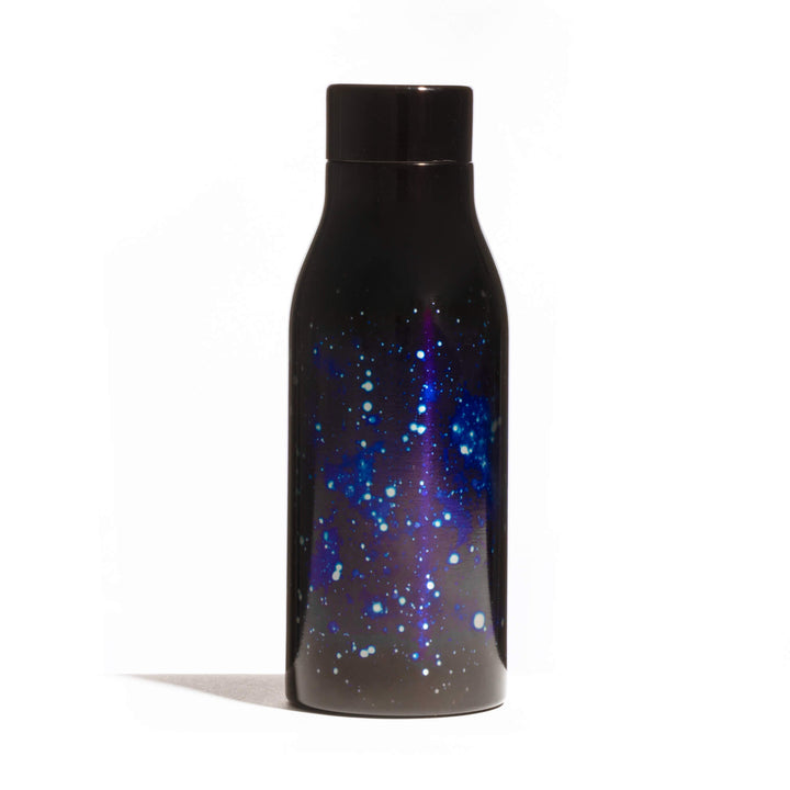 Seletti Cosmic Diner Thermal Bottle Galaxy, bottle turned slightly to show the wraparound galaxy print