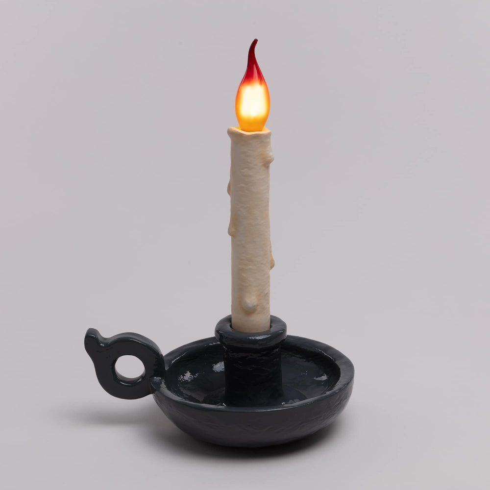 Seletti Bugia LED Candle Lamp Grey, charcoal gray base on a gray backdrop, flame bulb lit