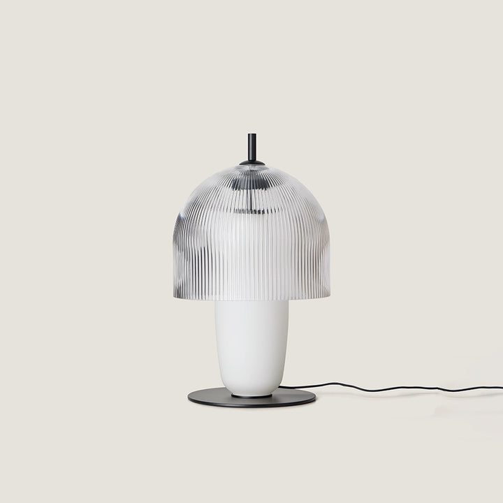Holm Table Lamp with a clear ribbed glass dome over an opal glass body on a black disc base, unlit, by Aromas del Campo