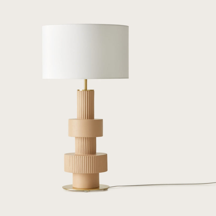 Babel Table Lamp with a stacked, ribbed sand-coloured ceramic base, brass disc foot and white drum shade, by Aromas del Campo