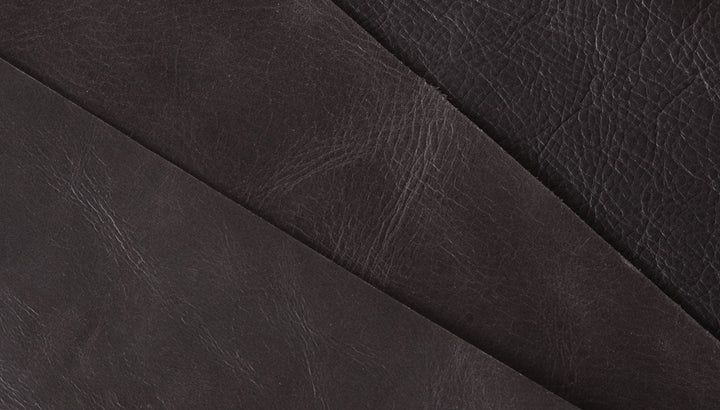 Rich dark leather upholstery with textured grain and elegant stitching detail