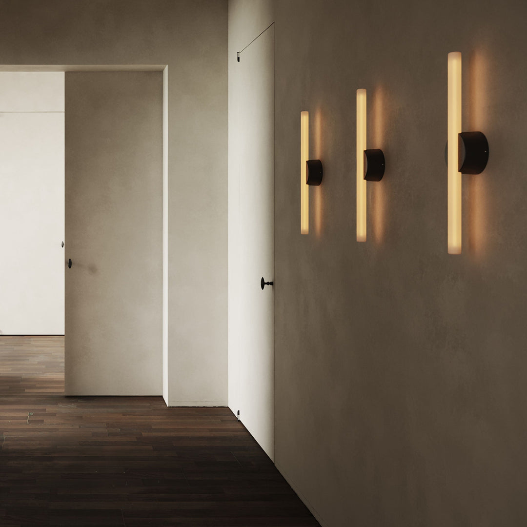 Modern wall sconces with warm glow, sleek black fixtures, minimalist hallway design