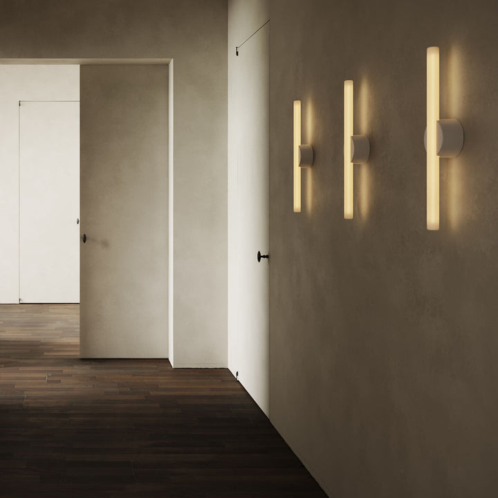 Modern wall sconces with warm glow, minimalist design, sleek concrete walls, dark wood flooring