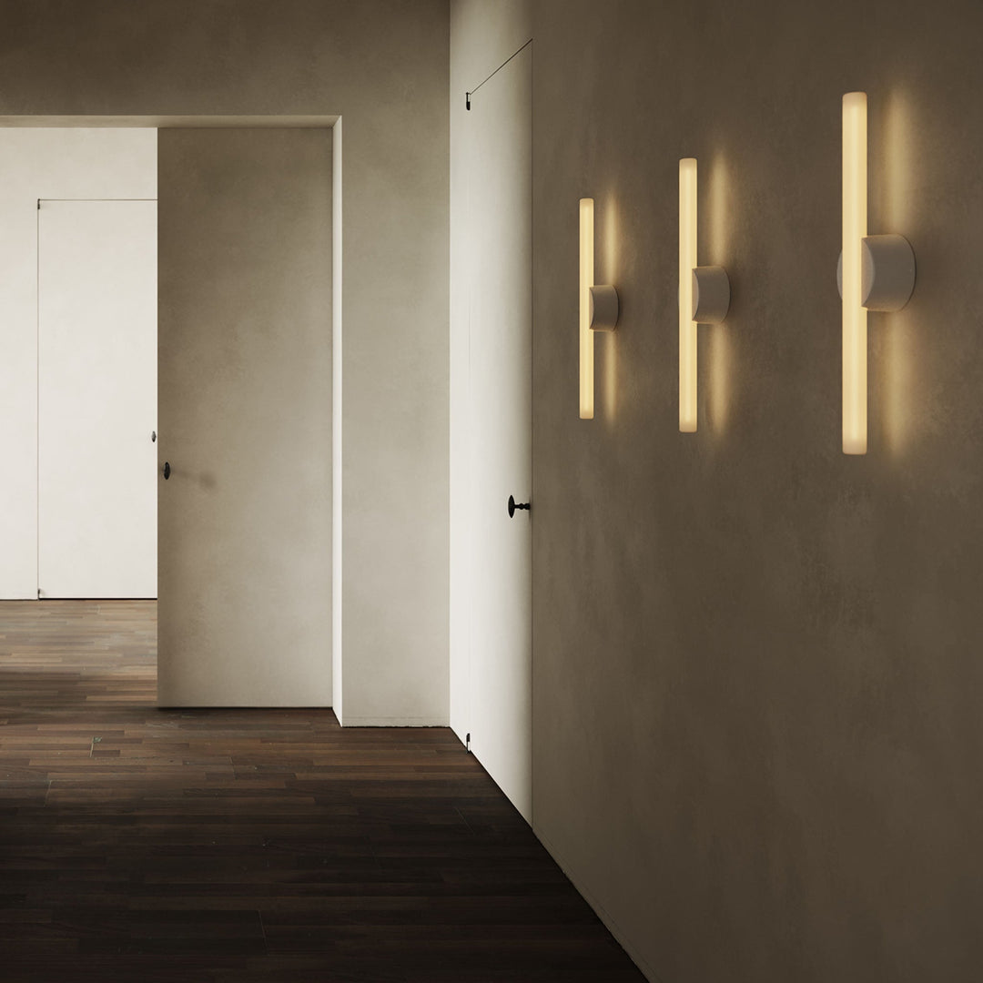 Modern wall sconces with warm glow, minimalist design, sleek concrete walls, dark wood flooring