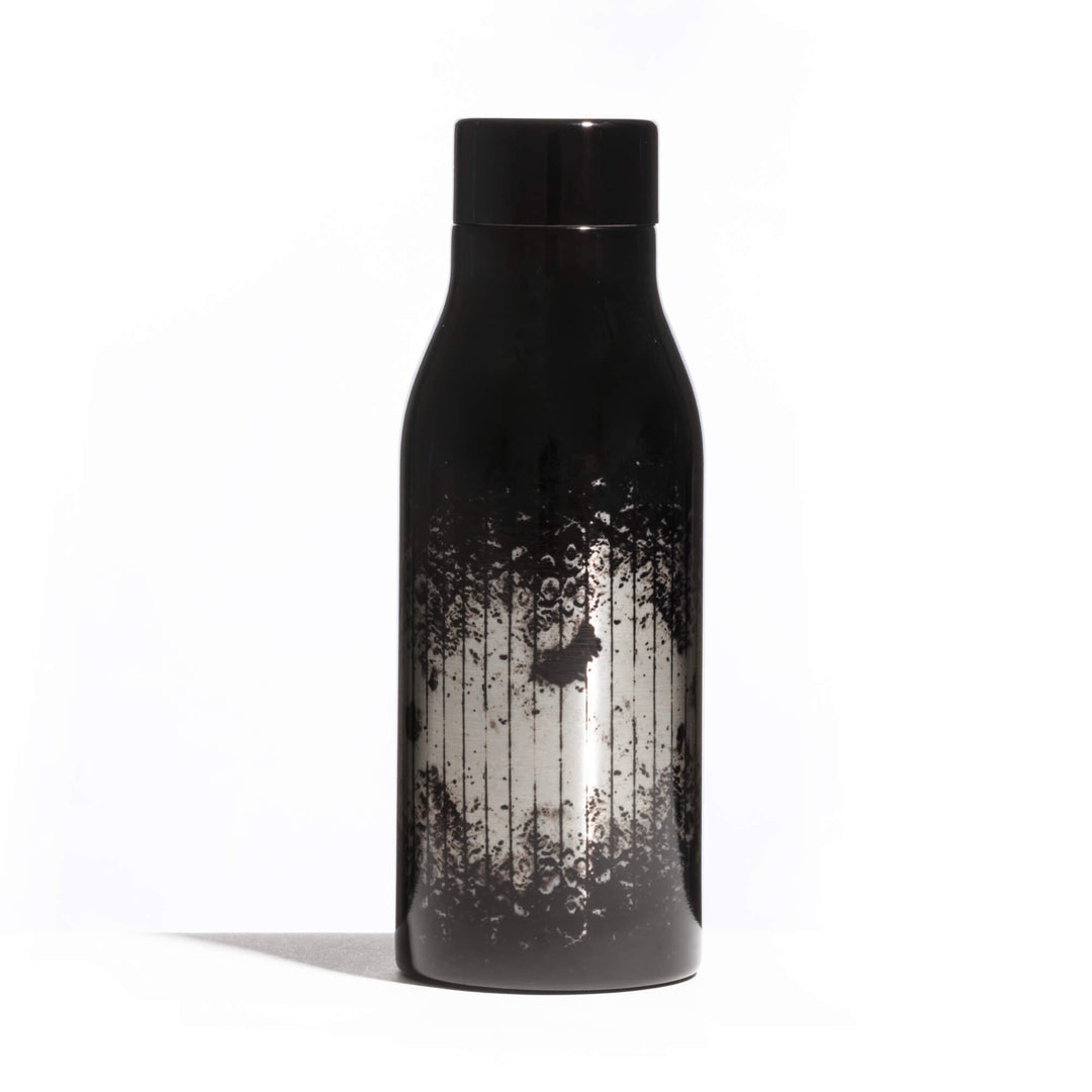 Seletti Cosmic Diner Thermal Bottle Lunar, side angle of the black and silver lunar print